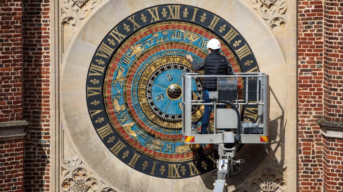 A conservator touches up the paintwork on an astronomical clock in London on Friday, May 5. The still-functioning clock was built in the year 1540.