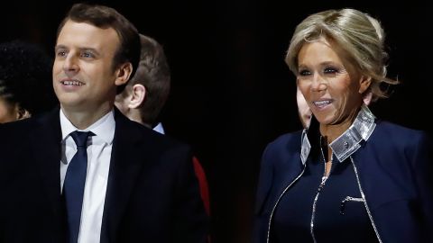 Emmanuel Macron and his wife Brigitte Trogneux are cheered by supporters in Paris on election night.