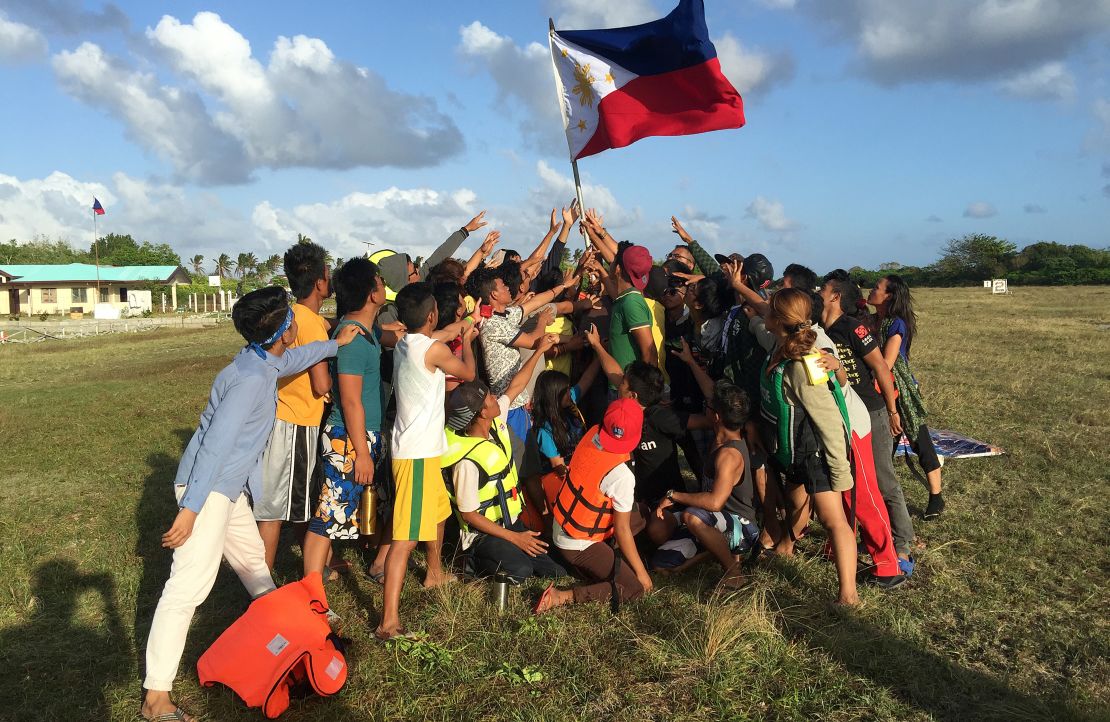 Filipino children hold up a national flag during a 2015 protest on Pagasa island against Beijing's claims in the South China Sea.