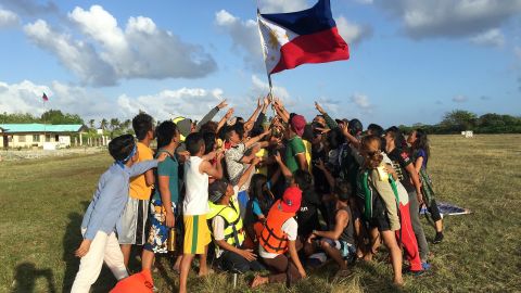 Filipino children hold up a national flag during a 2015 protest on Pagasa island against Beijing's claims in the South China Sea.