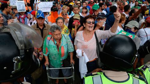 An elderly woman with a walker leads a group of desmonstrators during a grandparents' march on the streets of Venezuela's capital on Friday.