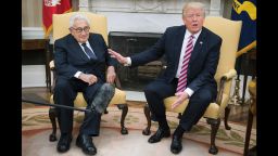 US President Donald Trump (R) speaks with former US Secretary of State Henry Kissinger during a meeting in the Oval Office of the White House in Washington, DC, May 10, 2017. / AFP PHOTO / JIM WATSON        (Photo credit should read JIM WATSON/AFP/Getty Images)