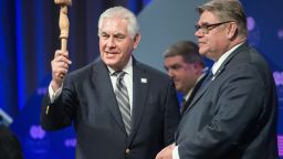 US Secretary of State Rex Tillerson holds the Arctic Council chair's gavel before handing it to Finnish Foreign Minister Timo Soini (R) as Finland becomes the chair during the plenary session of the Arctic Council meeting in Fairbanks, Alaska, on May 11, 2017. (NICHOLAS KAMM/AFP/Getty Images)