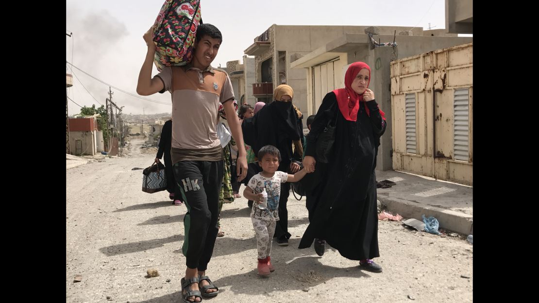 Residents flee an ISIS-controlled neighborhood in Mosul. 