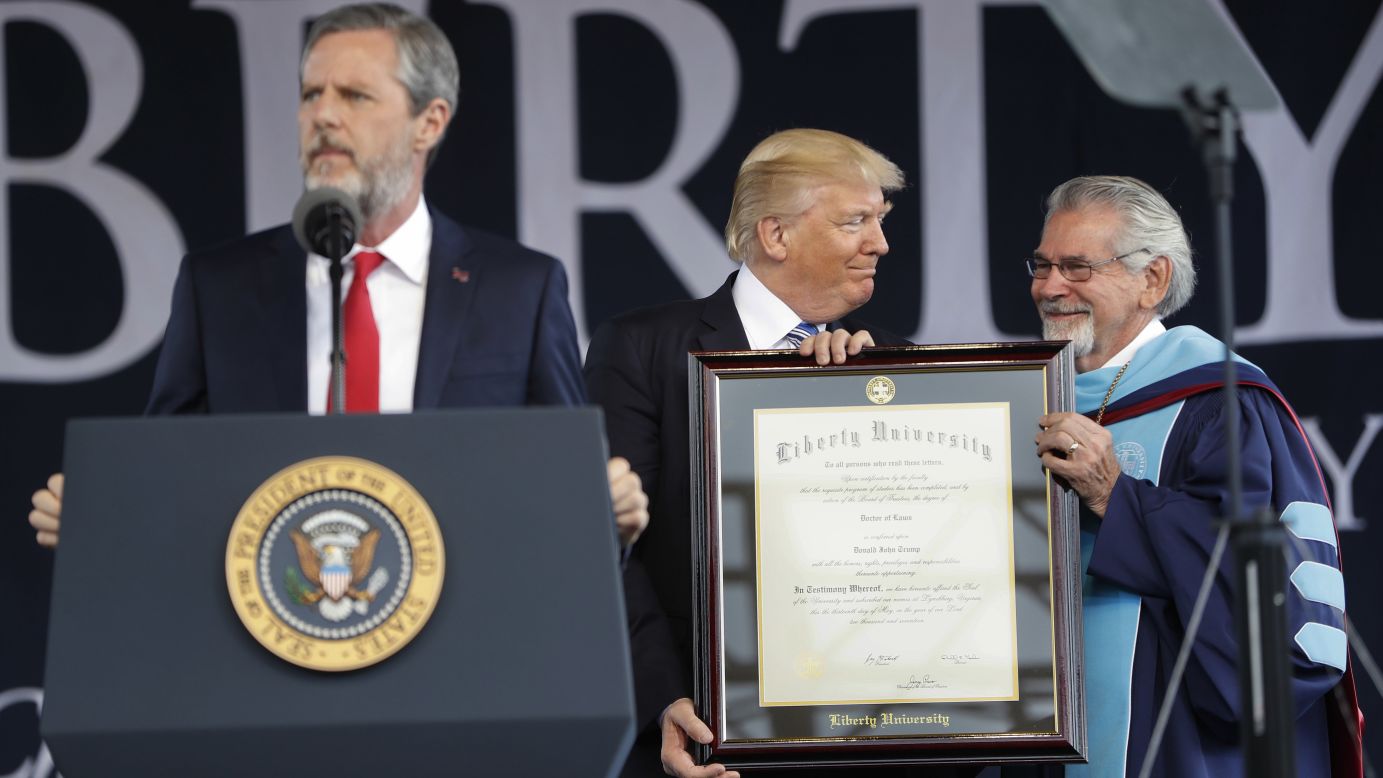 President Trump is presented with an honorary degree by Liberty University provost Ronald E. Hawkins, right, before <a href="http://www.cnn.com/2017/05/13/politics/trump-liberty-commencement-speech/" target="_blank">giving a commencement speech</a> in Lynchburg, Virginia, on Saturday, May 13. Speaking at the podium is Liberty University President Jerry Falwell. 