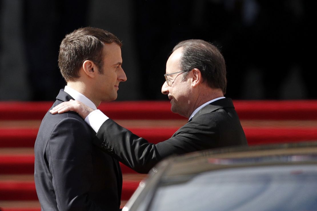 Emmanuel Macron shows his predessor, Francois Hollande, to his car at the Elysee Palace on Sunday. 