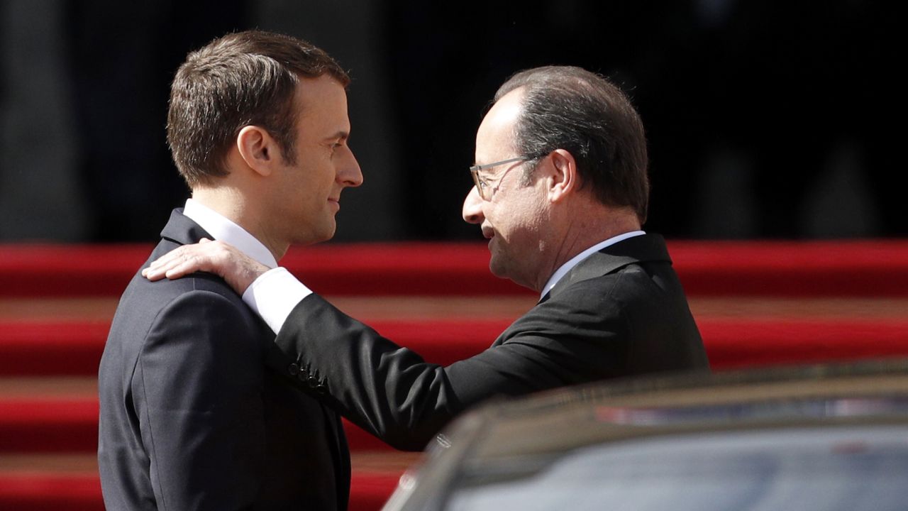 Emmanuel Macron shows his predessor, Francois Hollande, to his car at the Elysee Palace on Sunday. 