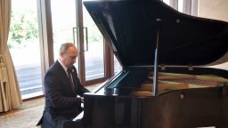 Russias President Vladimir Putin plays the grand piano ahead of a meeting with China's President Xi Jinping at the Diaoyutai State Guesthouse.