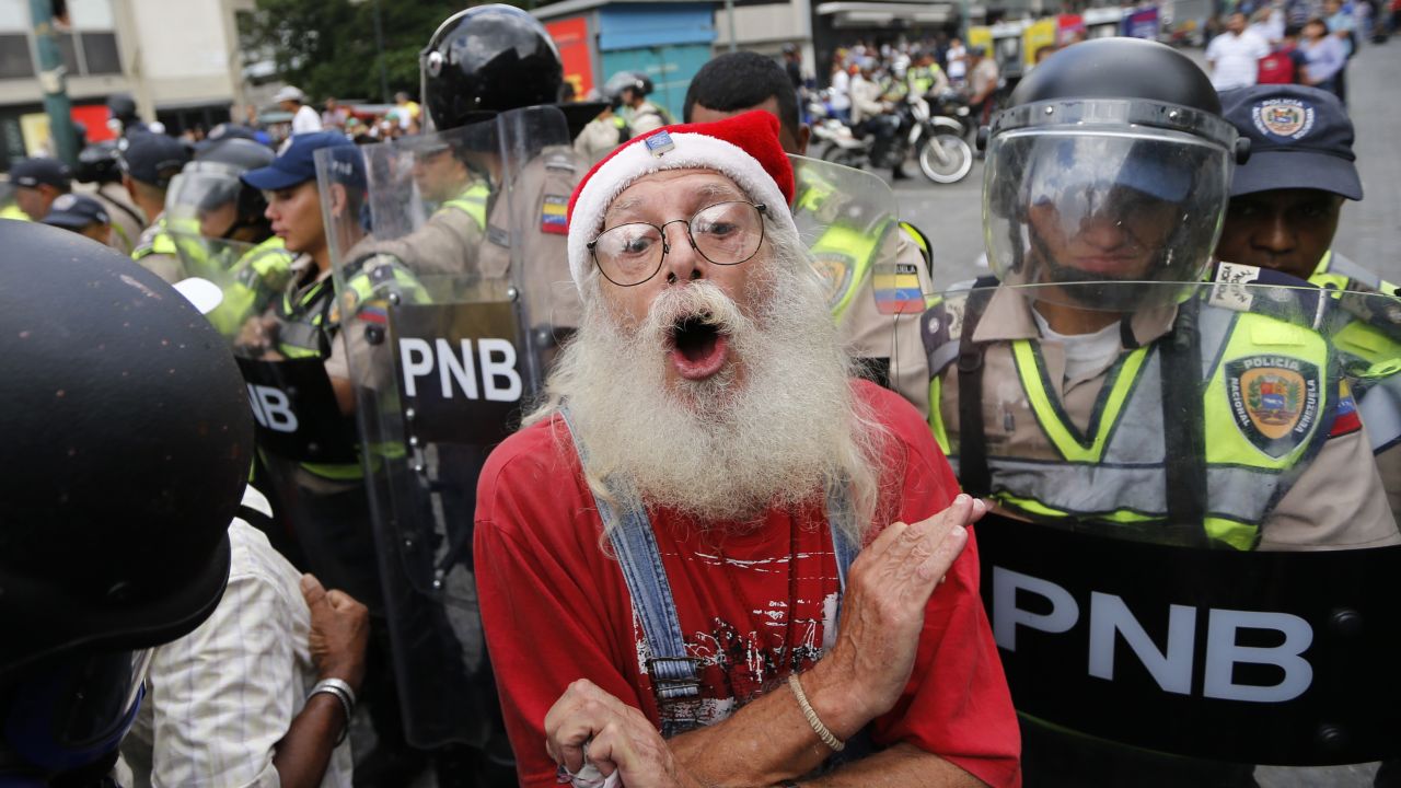 During a <a href="http://www.cnn.com/2017/05/12/americas/venezuela-grandparents-march/" target="_blank">"Grandparents' March"</a> in Caracas, a man is blocked by police from reaching the Government Ombudsman's Office on Friday, May 12.