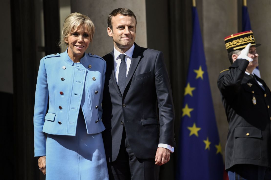 Emmanuel Macron poses with his wife, Brigitte Trogneux, at the presidential palace Sunday