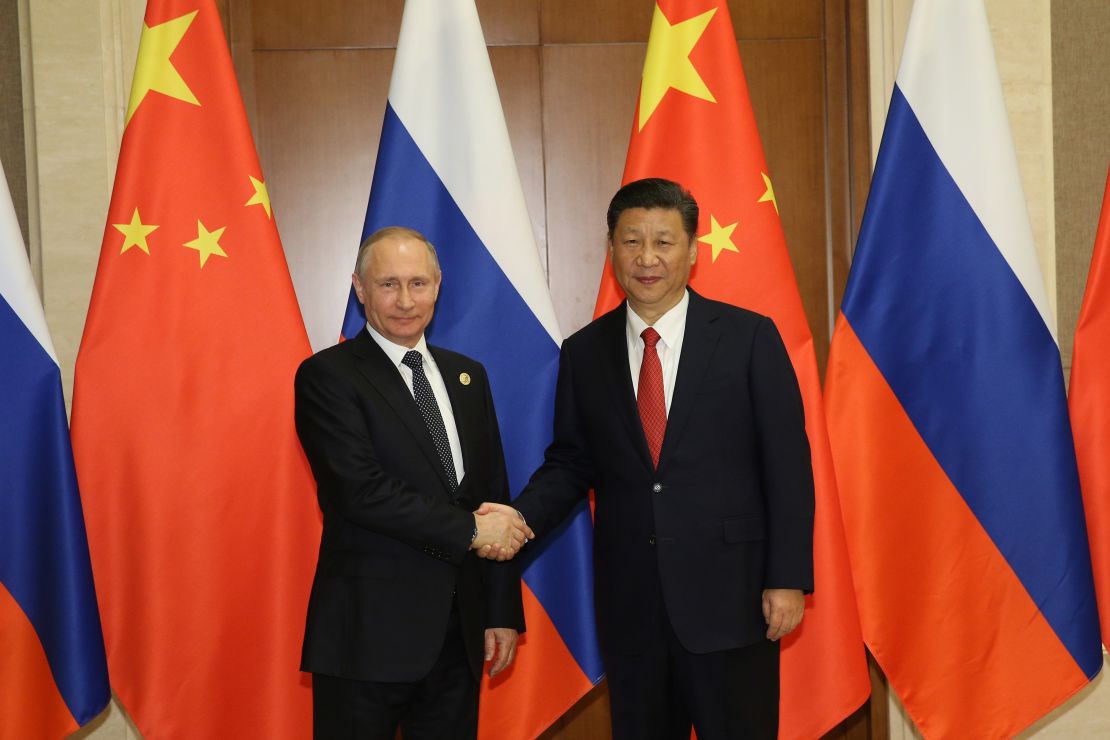 Russian President Vladimir Putin shakes hands with Chinese President Xi Jinping (Photo by Getty Images)