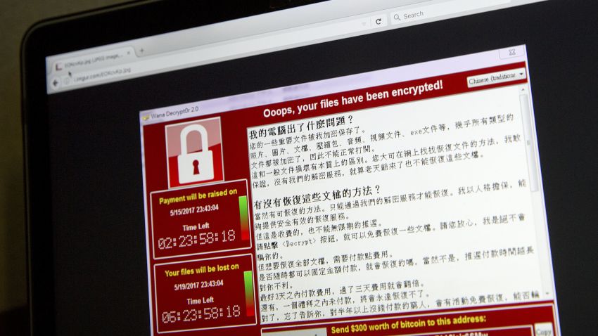 FILE - In this May 13, 2017 file photo, a screenshot of the warning screen from a purported ransomware attack, as captured by a computer user in Taiwan, is seen on laptop in Beijing.  Global cyber chaos is spreading Monday, May 14,  as companies boot up computers at work following the weekend's worldwide "ransomware" cyberattack. The extortion scheme has created chaos in 150 countries and could wreak even greater havoc as more malicious variations appear. The initial attack, known as "WannaCry," paralyzed computers running Britain's hospital network, Germany's national railway and scores of other companies and government agencies around the world.  (AP Photo/Mark Schiefelbein, File)