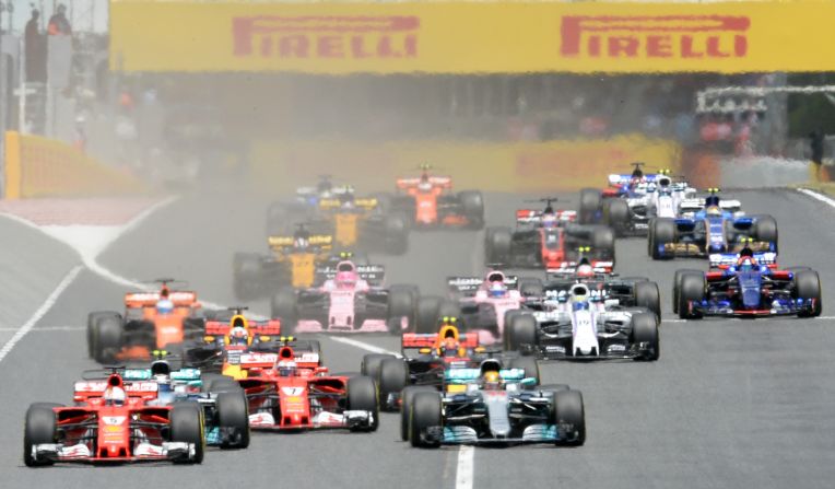 Ferrari's Sebastian Vettel (far left) took the lead at the start but it was Hamilton who eventually prevailed in the 66-lap race. 