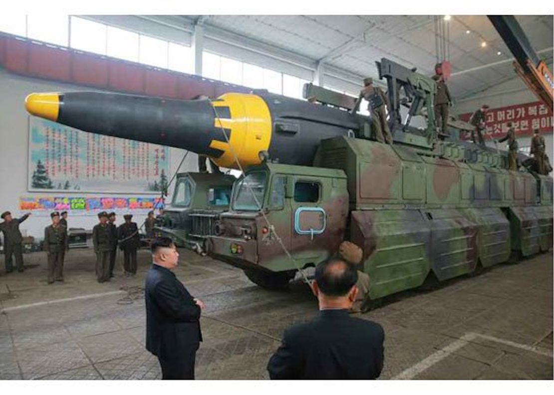 An image from North Korean state media shows leader Kim Jong with a missile on a mobile launcher.