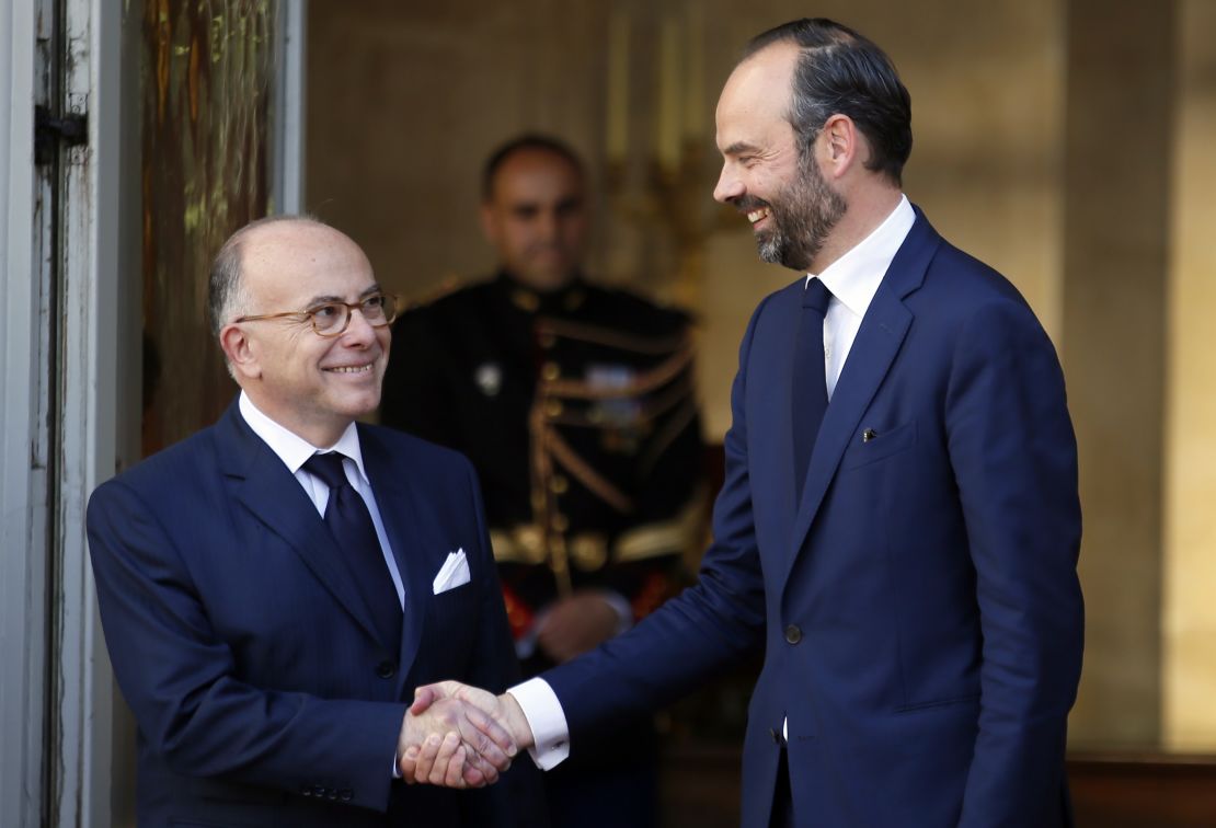 Philippe, right, shakes hands with outgoing Prime Minister Bernard Cazeneuve in Paris, Monday.