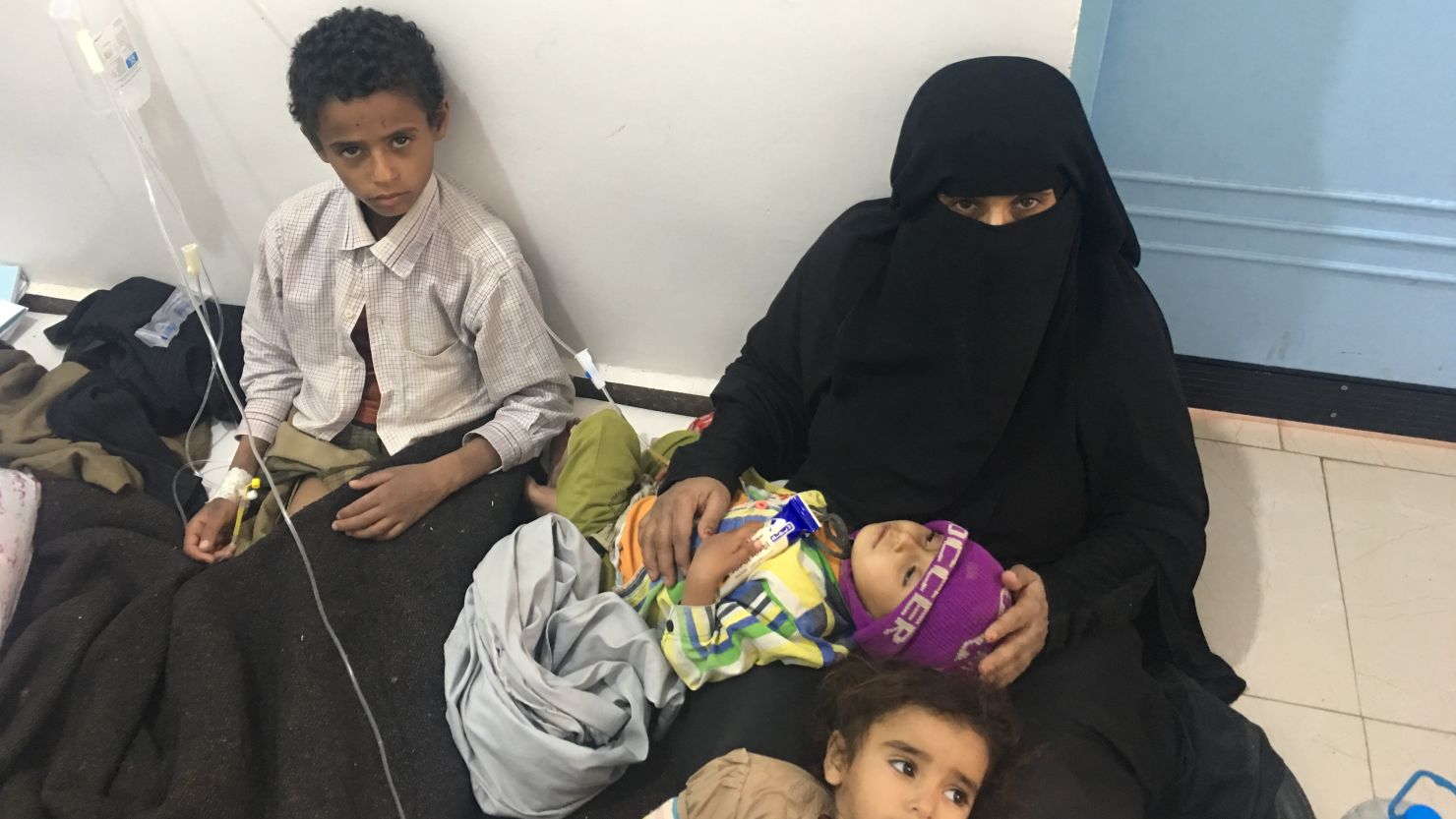 Fannah Mohammad comforts her daughters in Sabeen Children's Hospital in Sanaa.