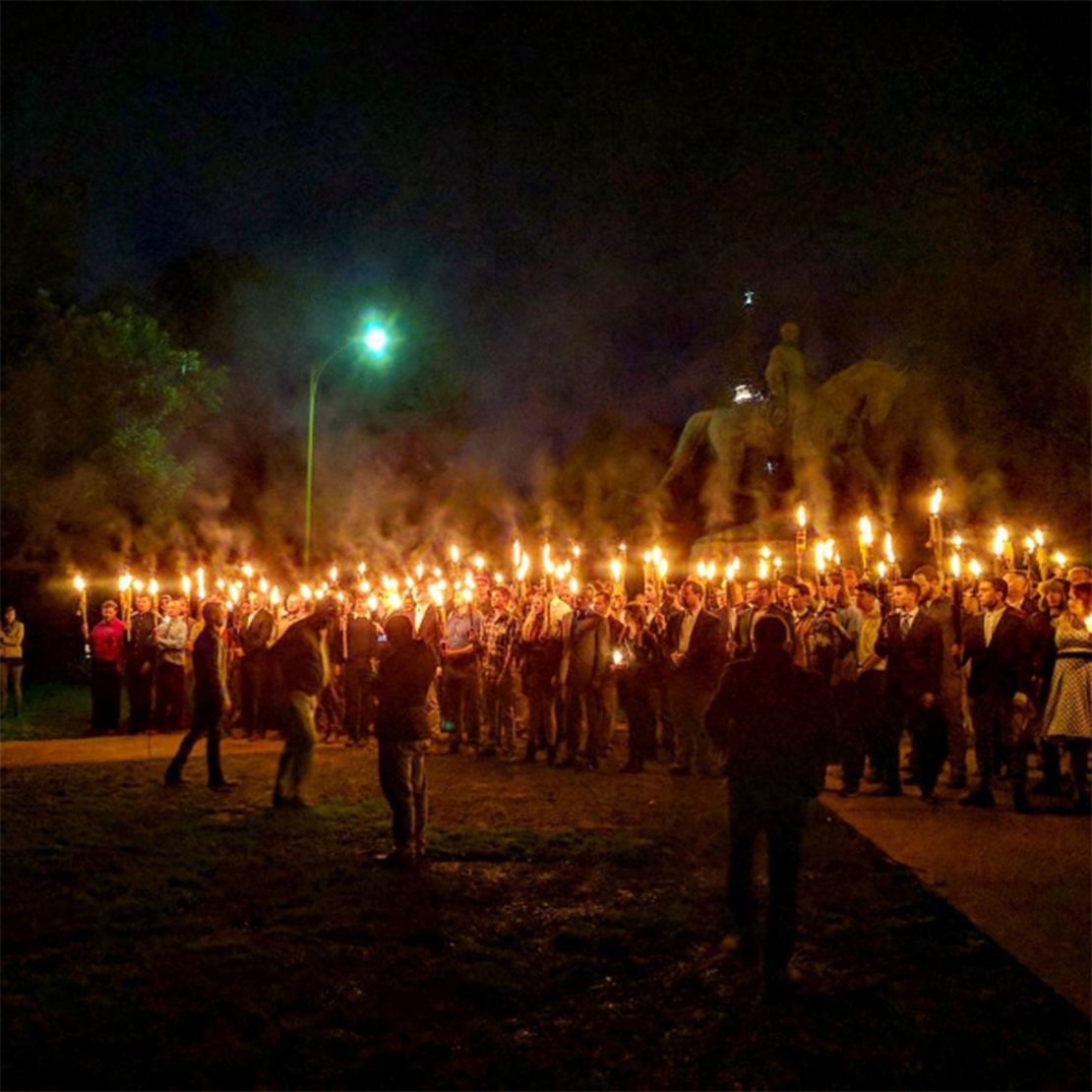 Torch-carrying demonstrators gather in Charlottesville on Saturday to protest the statue's removal.