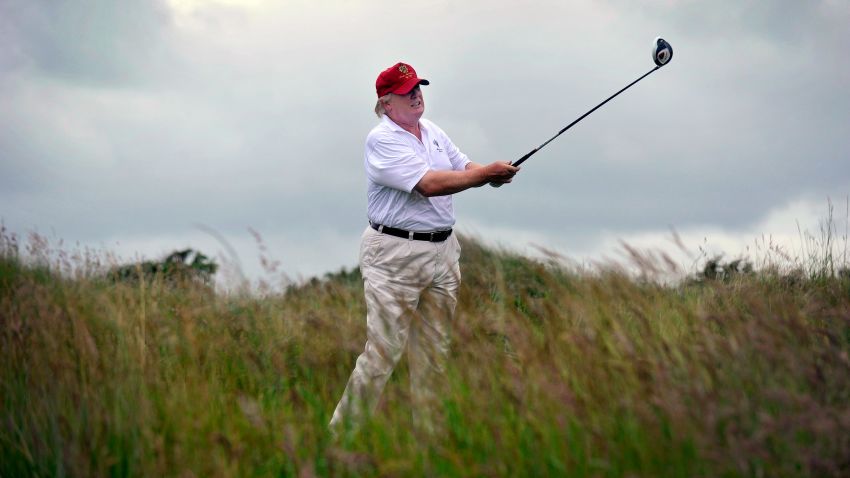 US tycoon Donald Trump plays a stroke as he officially opens his new multi-million pound Trump International Golf Links course in Aberdeenshire, Scotland, on July 10, 2012. Work on the course began in July 2010, four years after the plans were originally submitted.  AFP PHOTO / Andy Buchanan        (Photo credit should read Andy Buchanan/AFP/GettyImages)