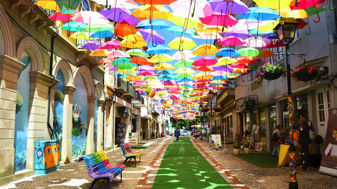 <strong>Annual Umbrella Sky Project, Agueda, Portugal: </strong>First popped open in 2011 during Agueda's art festival, the umbrellas sheltering the narrow streets of Agueda becomes an annual summer installation. 