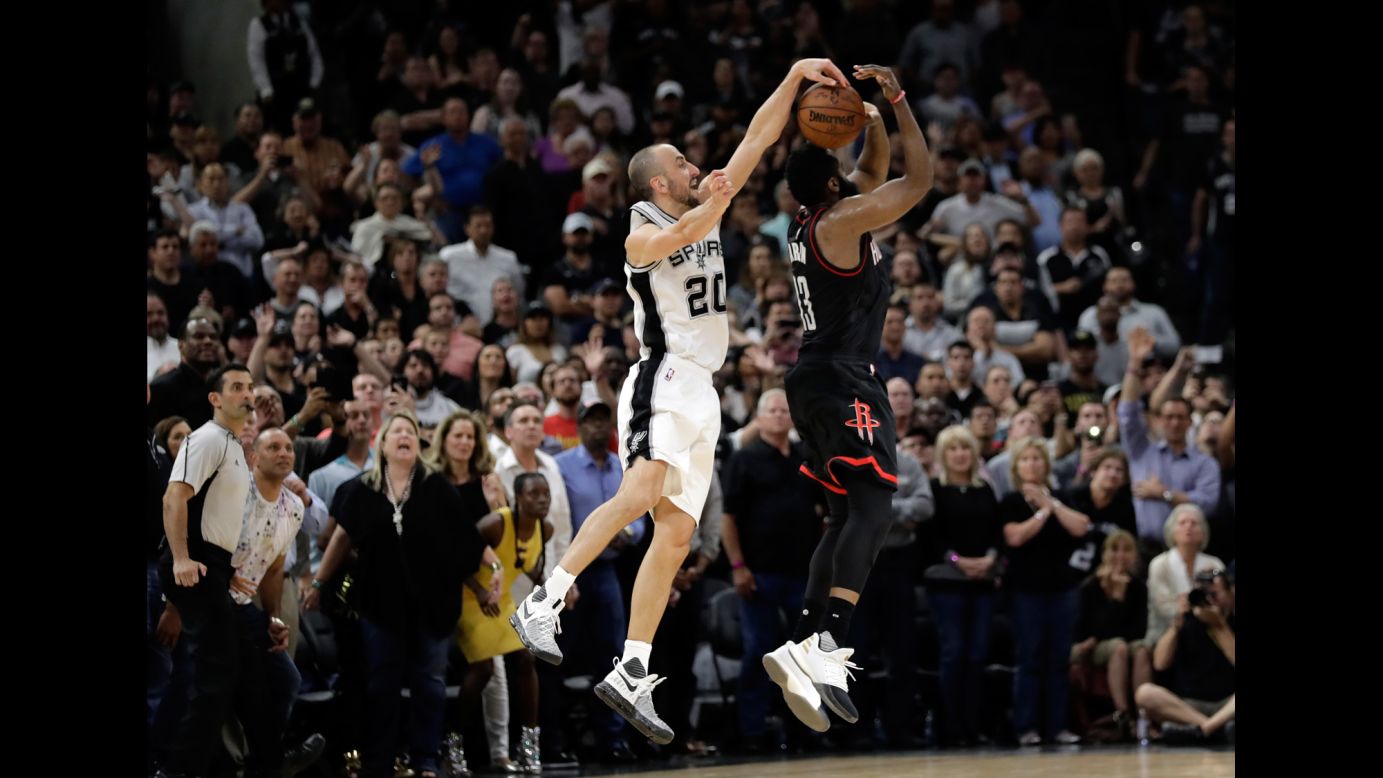 Manu Ginobili blocks James Harden as time expires, clinching a Game 5 playoff win for the San Antonio Spurs on Tuesday, May 9. The Spurs eliminated the Rockets one game later to advance to the NBA's Western Conference Finals.