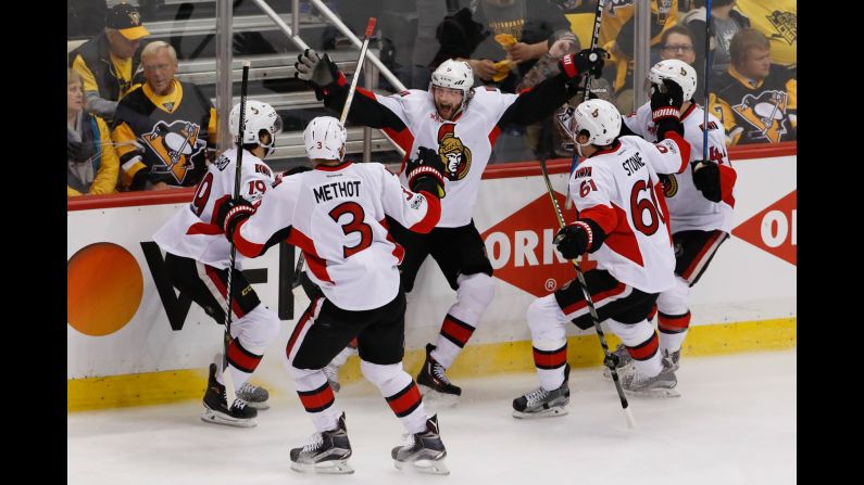 Ottawa's Bobby Ryan, center, is swarmed by his teammates after scoring an overtime goal to beat Pittsburgh in Game 1 of the NHL's Eastern Conference Final on Saturday, May 13.