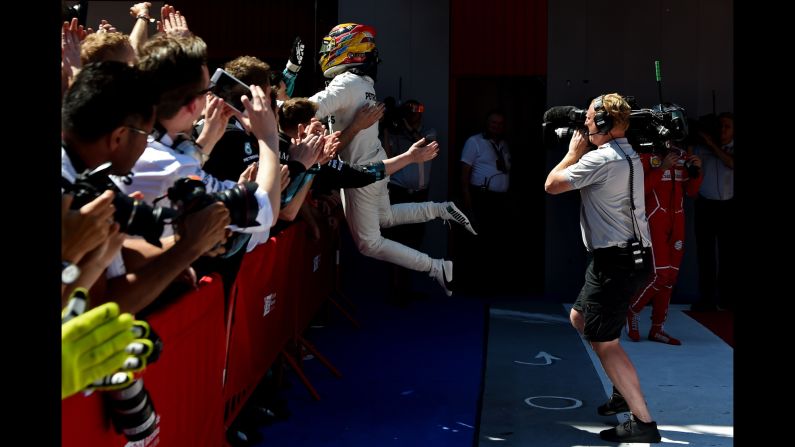 Formula One driver Lewis Hamilton celebrates with team members after <a href="index.php?page=&url=http%3A%2F%2Fwww.cnn.com%2F2017%2F05%2F14%2Fmotorsport%2Fspanish-grand-prix-hamilton-vettel%2Findex.html" target="_blank">winning the Spanish Grand Prix</a> on Sunday, May 14. <a href="index.php?page=&url=http%3A%2F%2Fwww.cnn.com%2F2017%2F05%2F09%2Fsport%2Fgallery%2Fwhat-a-shot-sports-0509%2Findex.html" target="_blank">See 29 amazing sports photos from last week</a>