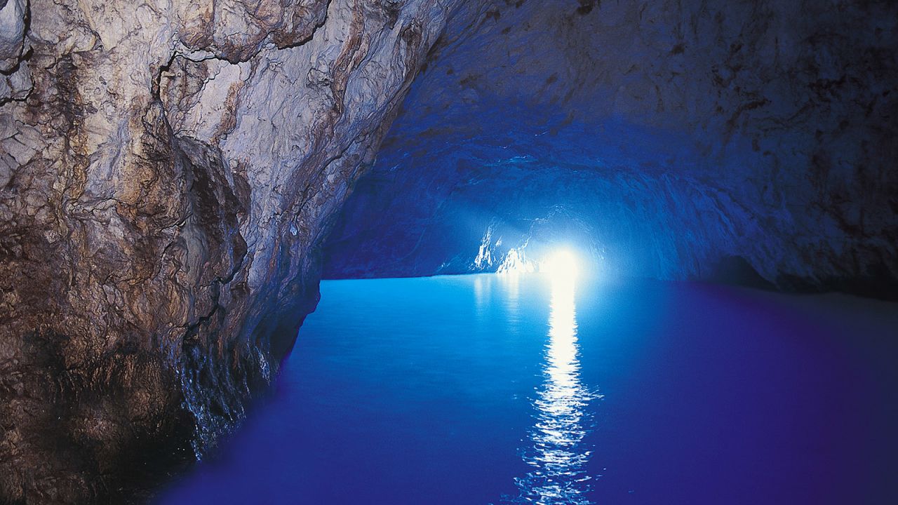 <strong>Blue Grotto, Capri: </strong>The Blue Grotto is a sea cave off the northwest coast of Capri, where sunlight illuminates the space with an azure hue. The entrance is less than a meter high, just enough for a small rowboat and its prone passengers to glide through.  
