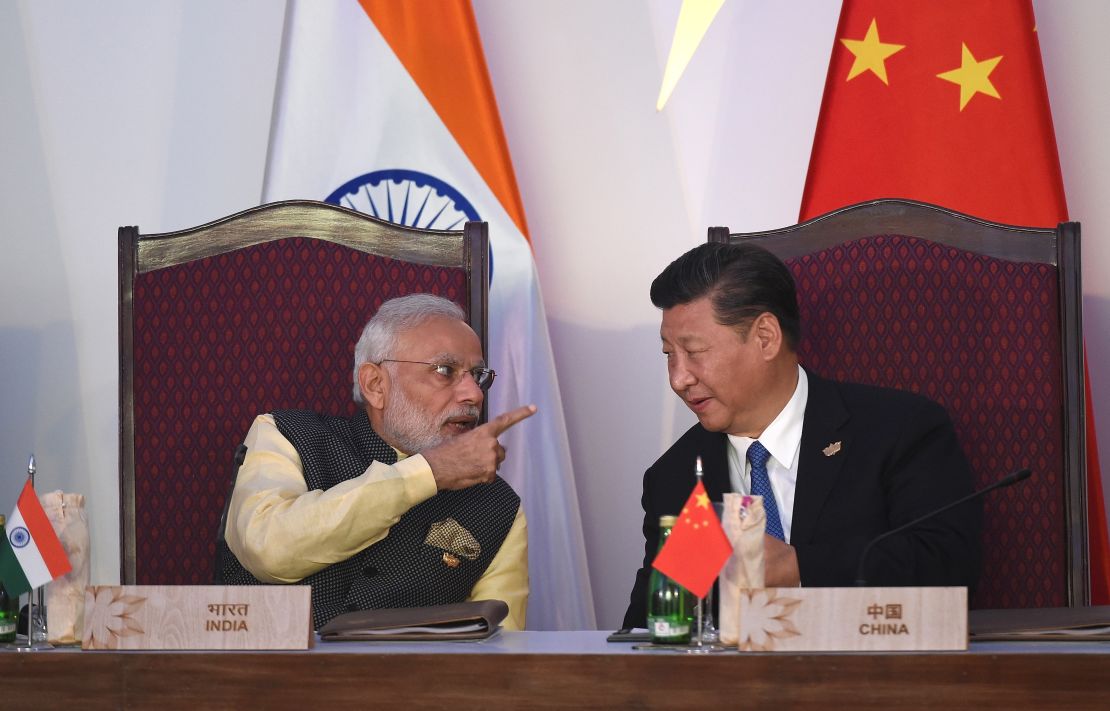 India Prime Minister Narendra Modi gestures while talking with China's President Xi Jinping in Goa on October 16, 2016.