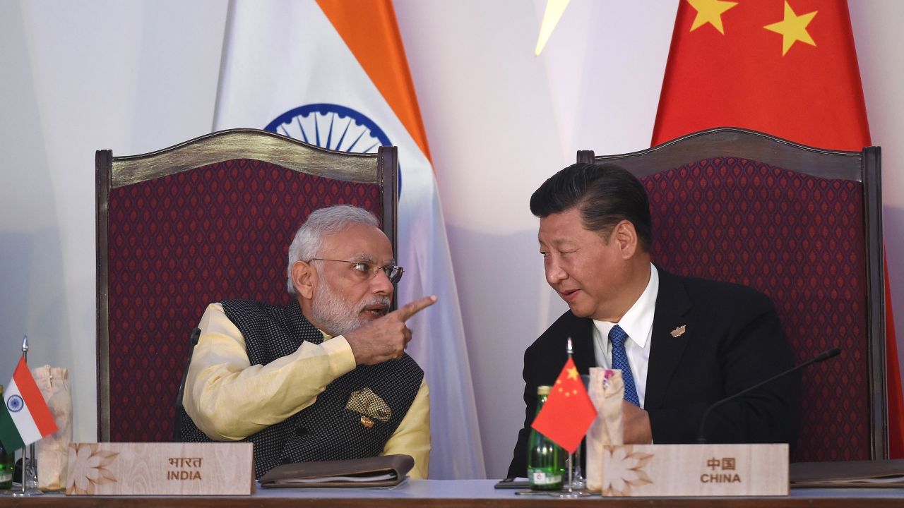 India Prime Minister Narendra Modi gestures while talking with China's President Xi Jinping in Goa on October 16, 2016.