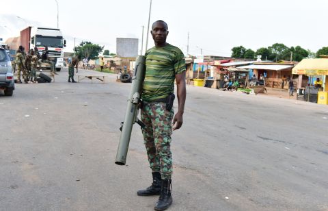 A mutinous soldier poses with a weapon in the streets of Ivory Coast's central second city Bouake during a four day uprising over unpaid bonus payments. <br /><br />Gunfire has been reported in several major cities after soldiers took to the streets. 