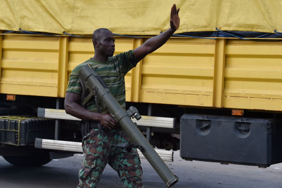 A rebel soldier directs traffic in Bouake. The mutineers took control of the main routes into the city.  