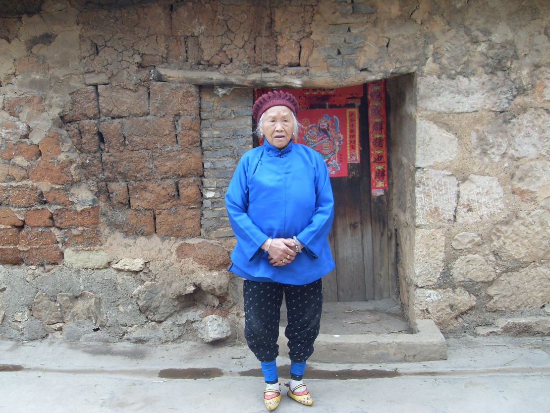 A woman with yellow embroidered shoes in Yunnan, China. 
