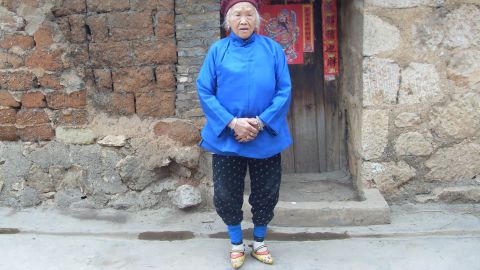 A woman with yellow embroidered shoes in Yunnan, China. 