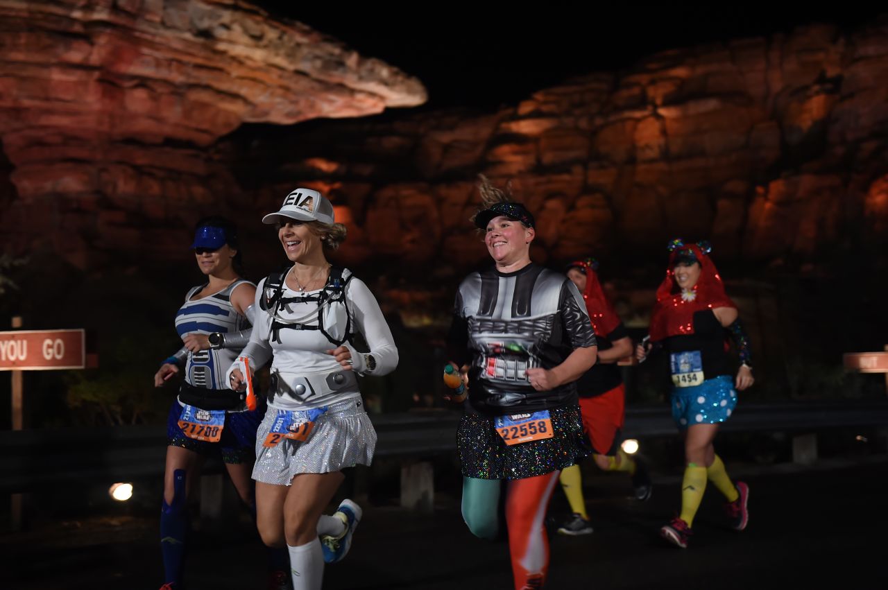 The course goes through Disneyland and Disney Adventure Park, including past the lit-up canyons of Cars Land from the animated film "Cars."