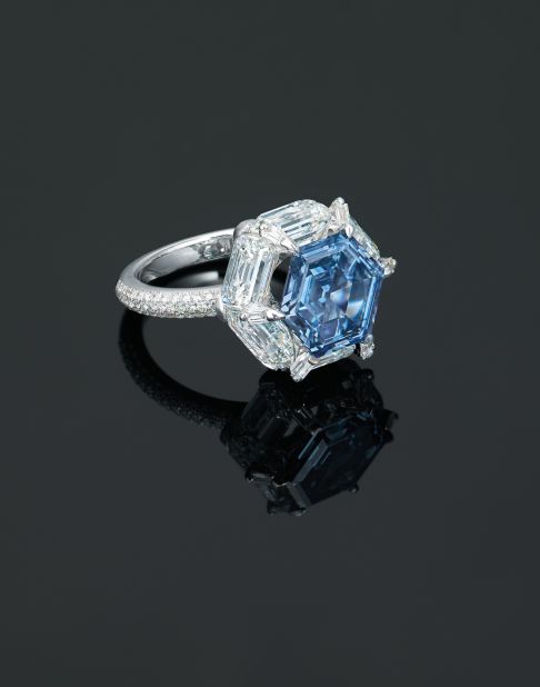 This ring by Edmond Chin features a hexagonal-shaped 3.37 carat blue diamond, encircled with tapered diamonds.