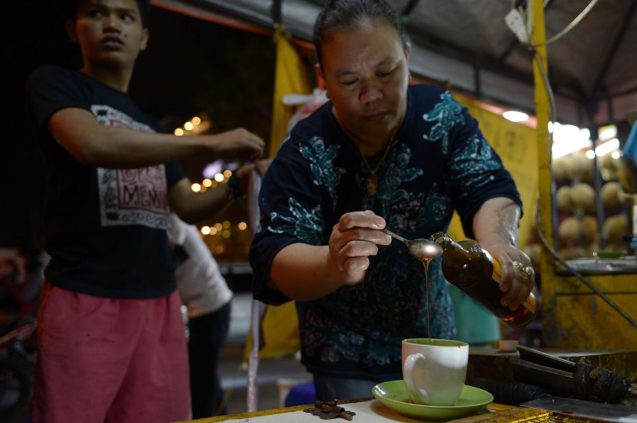 <strong>Cobra blood:</strong> In Indonesia, cobra blood, bile and marrow is mixed with honey at the roadside. Young men will roll up to stalls like this in Jakarta and down the potent concoction, said to have libido-boosting properties.