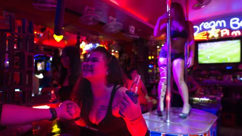 PATTAYA,THAILAND -JULY 31, 2016:  Bar girls entertain men at a bar along the Walking Street where bars and sex scenes are a commonplace July 31, 2016 in Pattaya, Thailand. Thailand's first female minister of tourism would like the sex trade that is a huge business in the country to be banned. Tourists flock to Thailand for many sights including beautiful beaches but also for sex tourism. Cities like Bangkok and Pattaya are well known as hubs of the Southeast Asian sex trade, despite the fact that prostitution has been illegal in Thailand since 1960.(Photo by Paula Bronstein/ Getty Images)