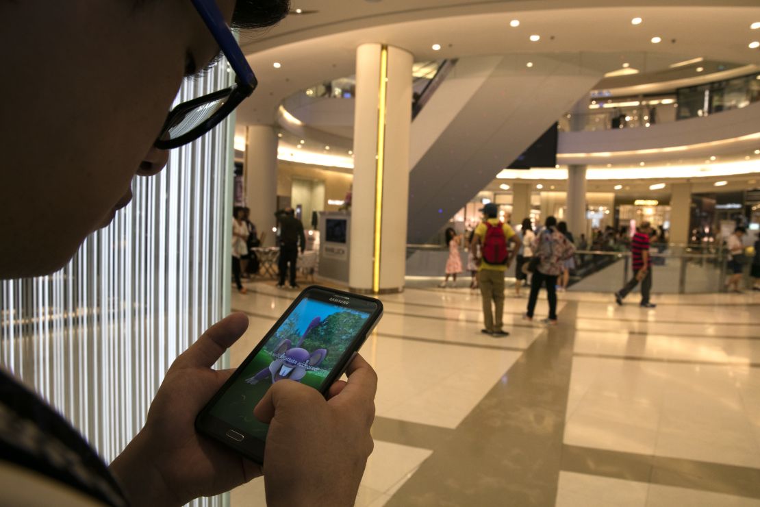 This shopper is more preoccupied with Pokemon Go than grabbing bargains.