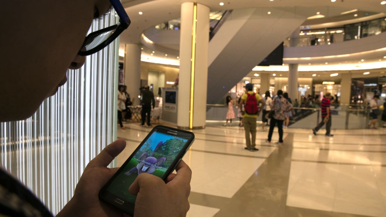 This shopper is more preoccupied with Pokemon Go than grabbing bargains.