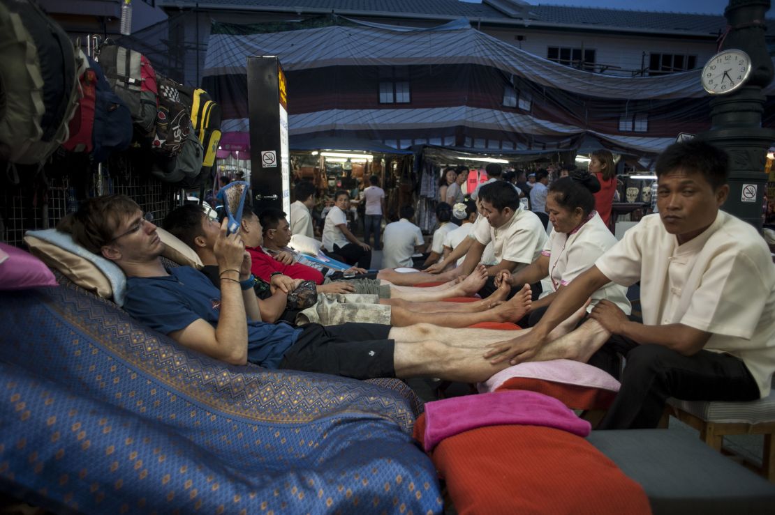 Tourists get a foot massage in Khao San road in Bangkok, Thailand.
