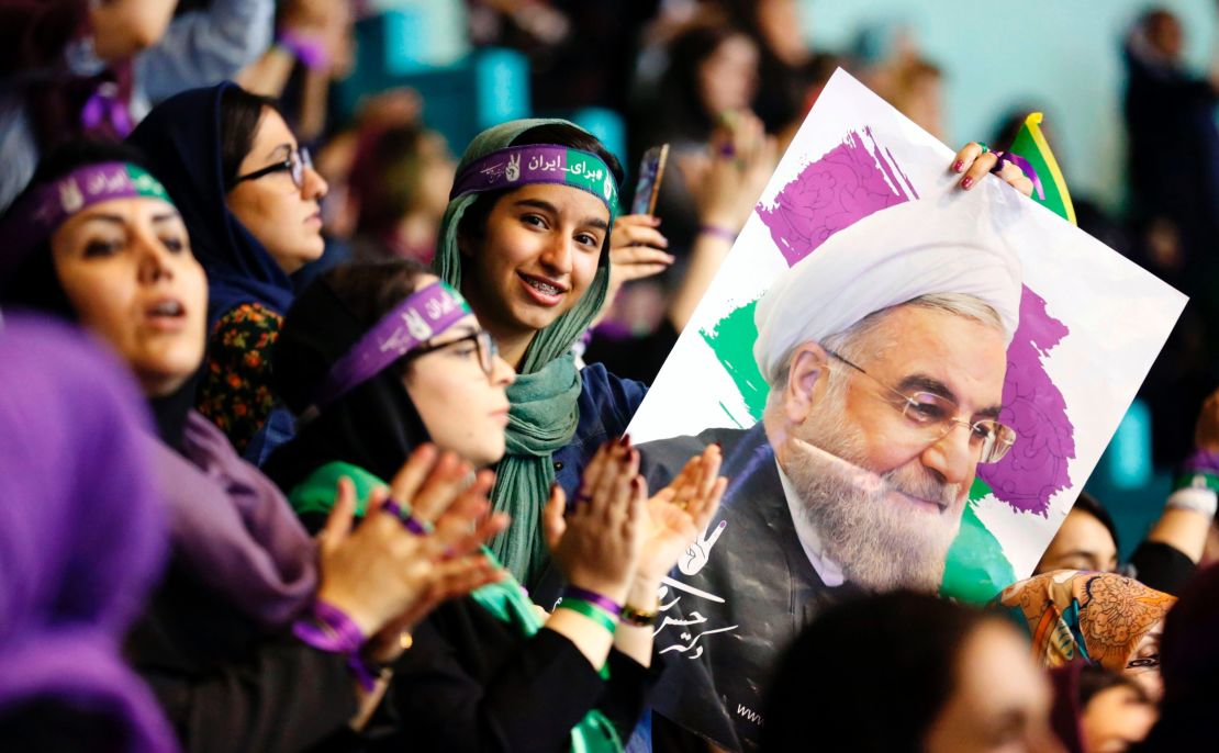 Rouhani supporters wave his portrait and chant slogans at a rally in Tehran.