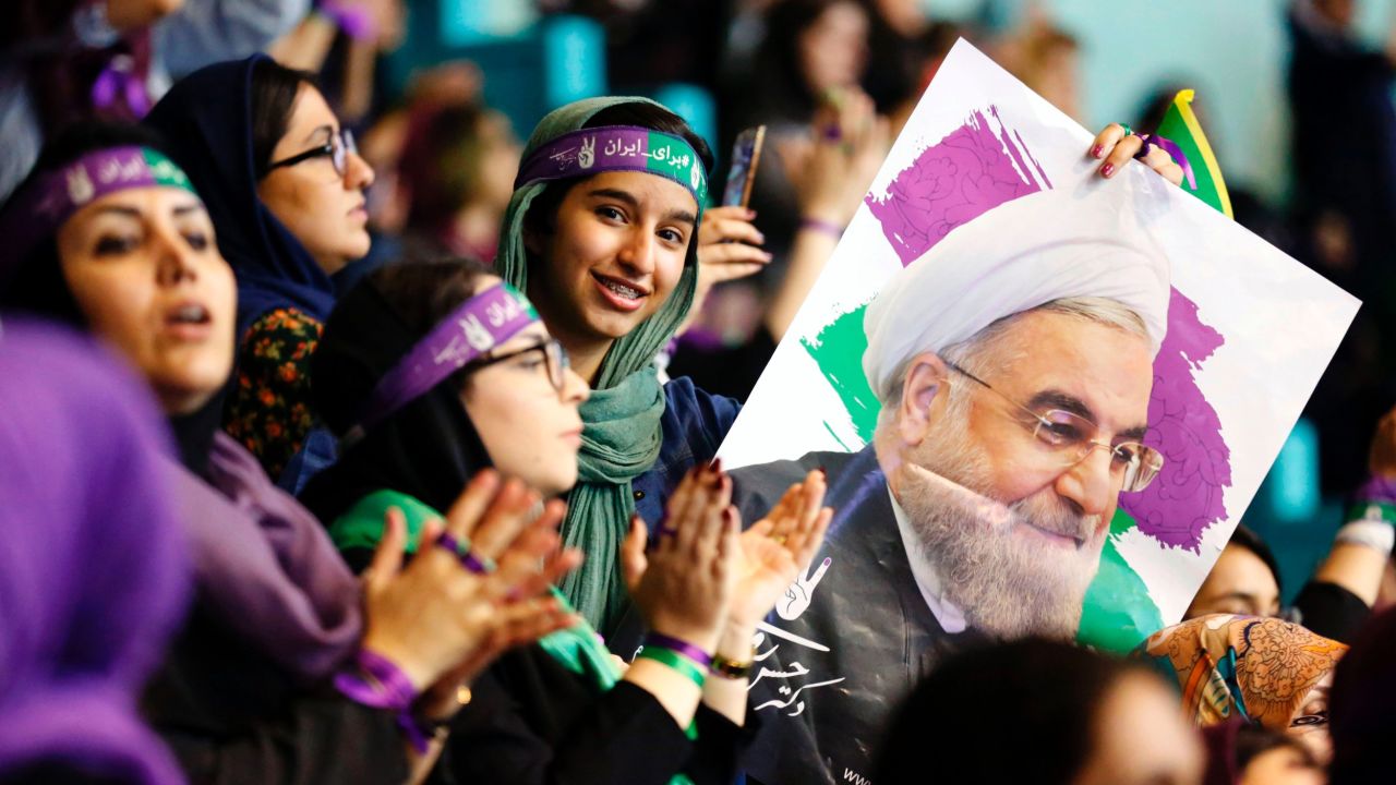 Rouhani supporters wave his portrait and chant slogans at a rally in Tehran.