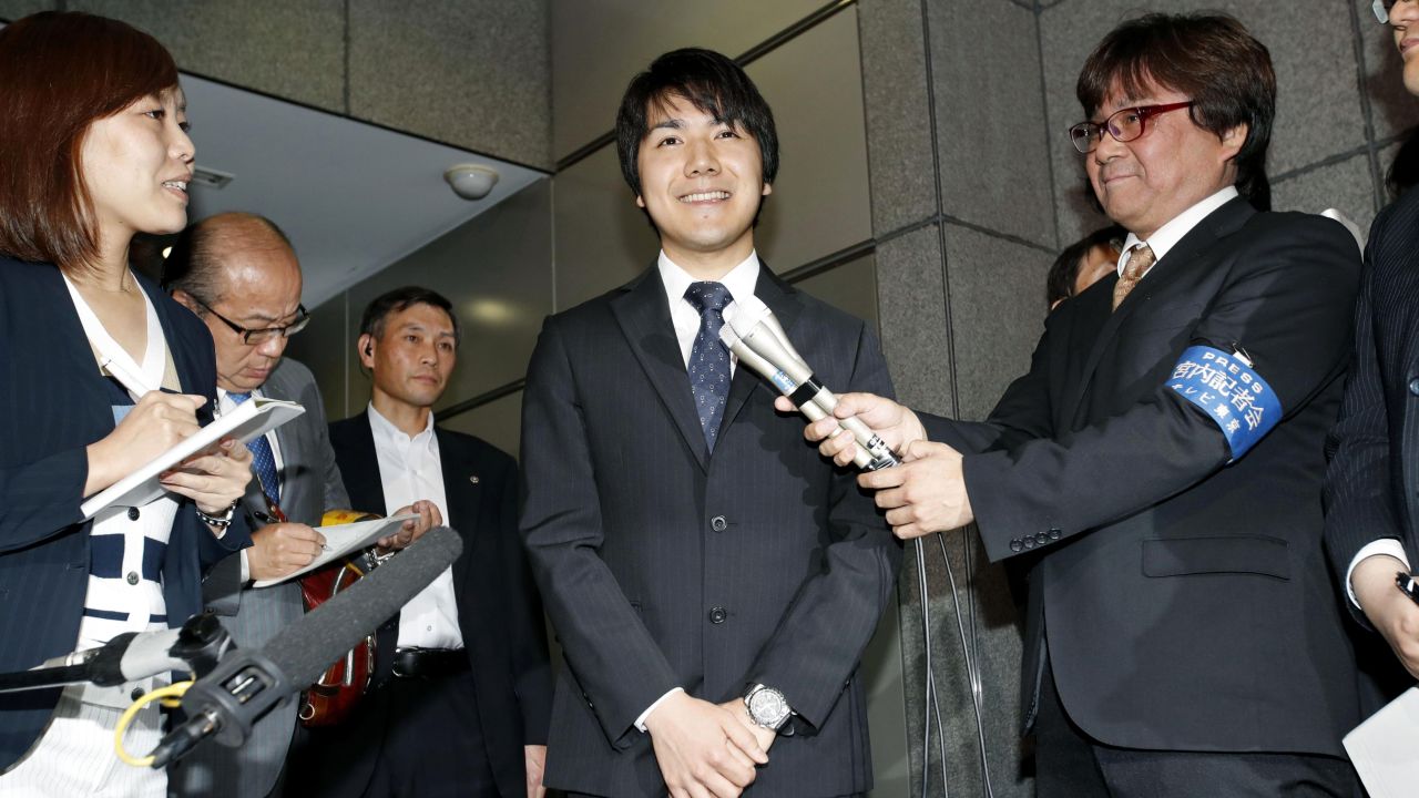 Kei Komuro, center, is interviewed by reporters in Tokyo Wednesday, May 17 2017.