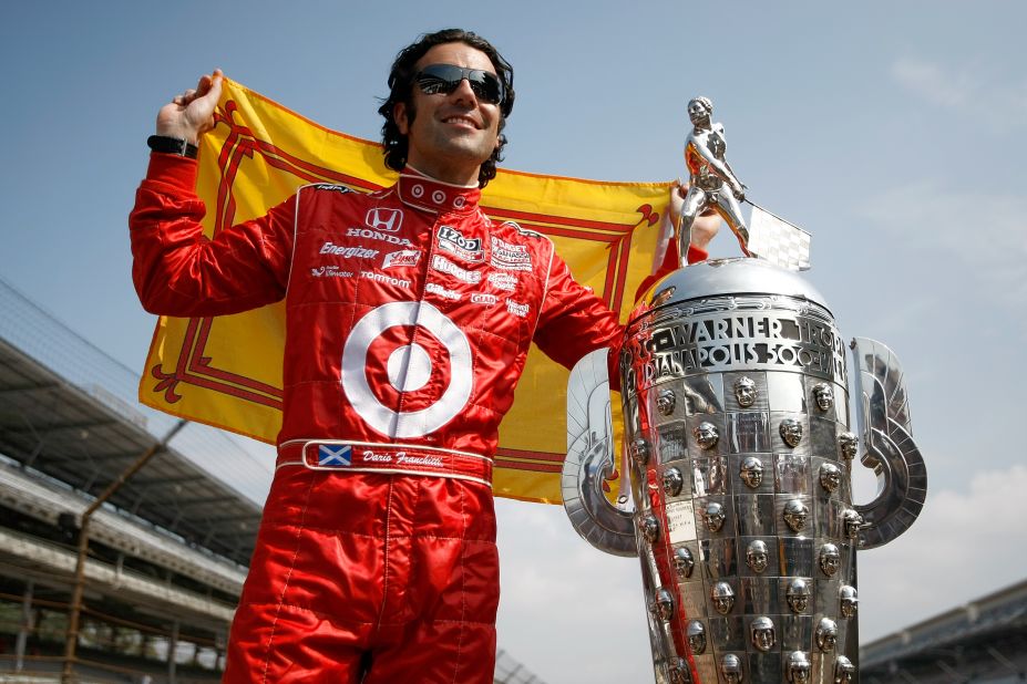 Scottish driver Dario Franchitti, who won the Indy 500 on three occasions, poses with the trophy at the Brickyard in 2010. 