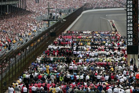 Drivers and their teams fill the track for the US national anthem in 2008.