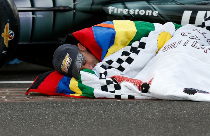 Since 1976, Jeanetta Holder, a long-time fan of the Indy 500, has produced a custom-made quilt for the winner, earning her the title "Quilt Lady." Here, 2013 champion Tony Kanaan snuggles up in his prize blanket. 