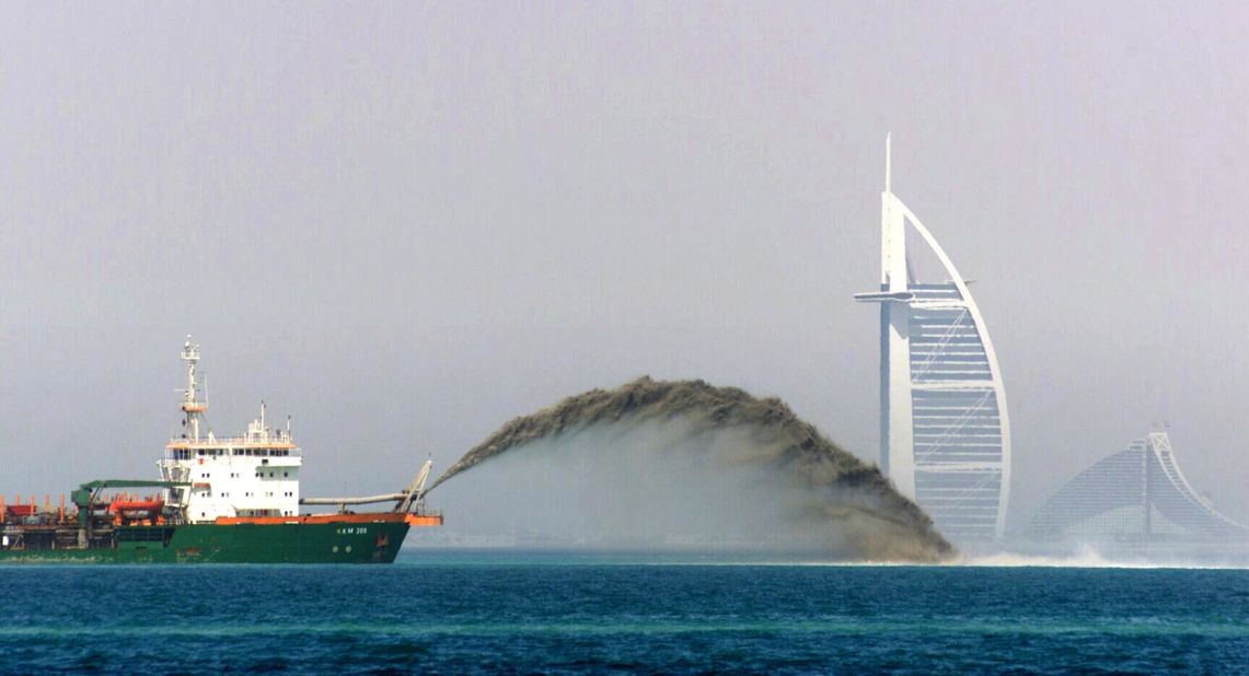 A dredger barge pumps sand onto the sea bed three miles off the Dubai coast in 2002 during the construction of the Palm Jumeirah.