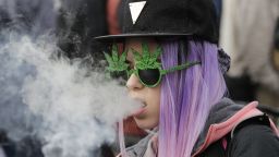 A resident smokes a large marijuana joint during the 420 Day festival on the lawns of Parliament Hill in Ottawa, Ontario, Canada, on Thursday, April 20, 2017. 