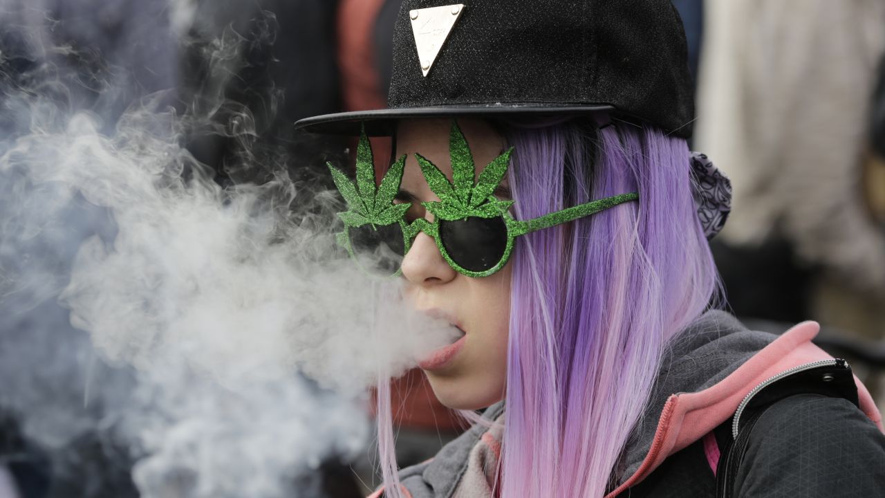 A resident smokes a large cannabis joint during a marijuana festival last year.