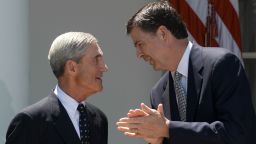 FBI director nominee Jim Comey (R) applauds outgoing FBI director Robert Mueller in the Rose Garden at the White House in Washington on June 21, 2013. 